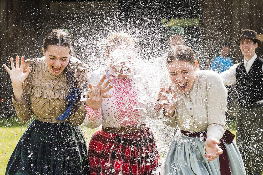 Women in traditional costumes are sprayed with water by men as members of the Marghareta Dance Group perform Easter folk traditions of the region in the Museum Village in Nyiregyhaza, 227 kms northeast of Budapest, Hungary, Monday, April 21, 2014. According to a hundred years old tradition of Hungarian villages, young men pour water on young women who in exchange present their sprinklers with beautifully coloured eggs on Easter Monday. (AP Photo/MTI/ Attila Balazs) ORG XMIT: MTI105