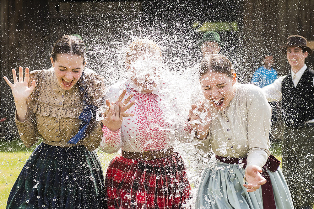 Women in traditional costumes are sprayed with water by men as members of the Marghareta Dance Group perform Easter folk traditions of the region in the Museum Village in Nyiregyhaza, 227 kms northeast of Budapest, Hungary, Monday, April 21, 2014. According to a hundred years old tradition of Hungarian villages, young men pour water on young women who in exchange present their sprinklers with beautifully coloured eggs on Easter Monday. (AP Photo/MTI/ Attila Balazs) ORG XMIT: MTI105
